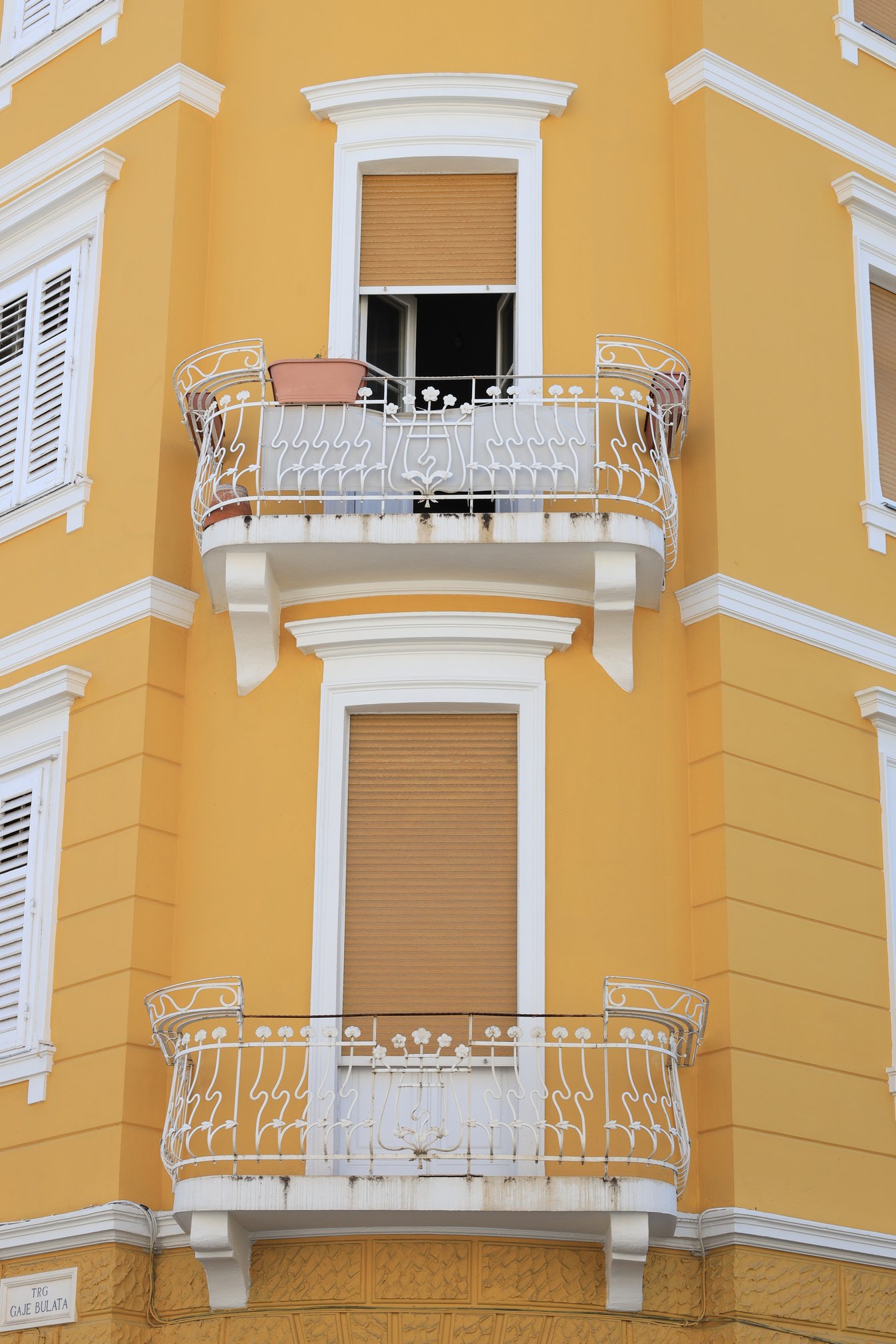 View of Beautiful Yellow Building with Balconies Outdoors